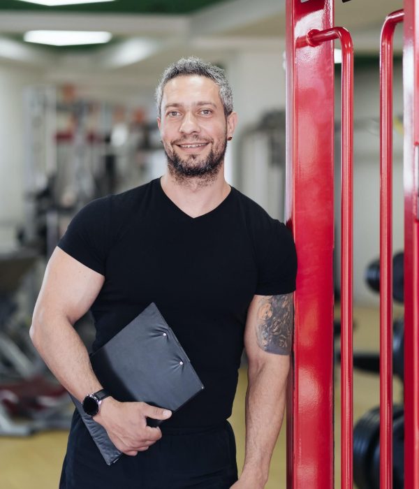 personal-fitness-trainer-with-workout-plan-close-up-on-gym-background-1.jpg